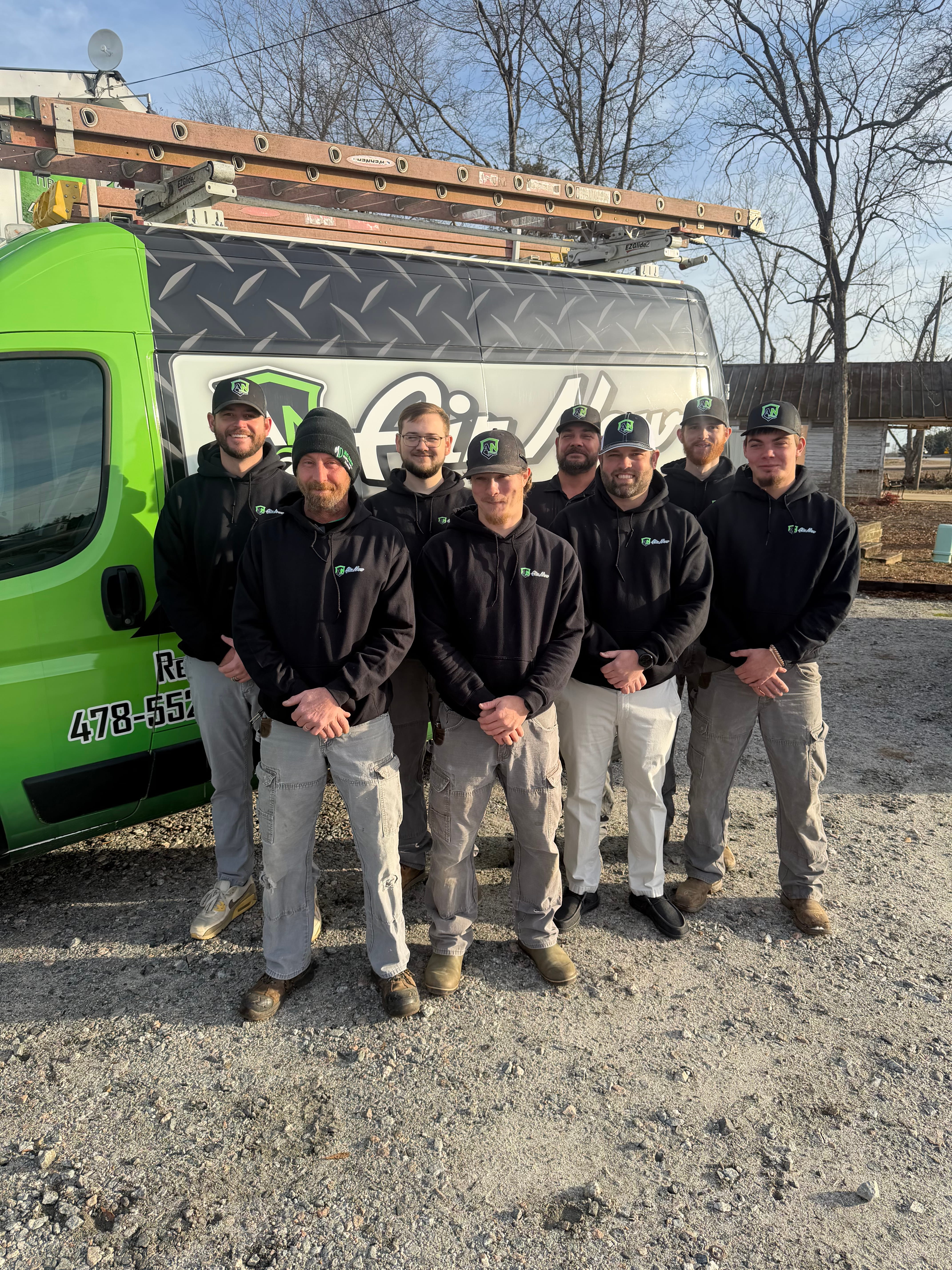 The team at AirNow posing by one of their branded trucks in Augusta